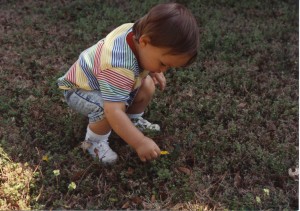 curious boy in grass by KC OK